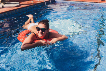 Portrait beautiful young asian women happy smile relax outdoor swimming pool in resort hotel for vacation travel.