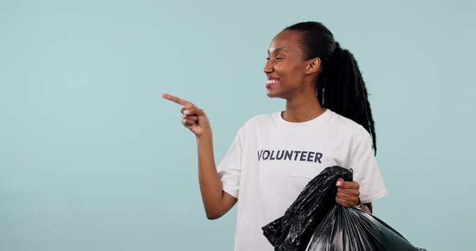 Plastic bag, black woman point or volunteer thumbs up for trash cleaning agreement, climate change feedback or recycling. Studio mockup space, NGO vote or Nonprofit portrait person on blue background