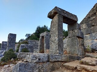 Pinara ruins of an ancient city near Fethiye, Mugla, Türkiye. Lycian tombs, ancient Roman amphitheater and mountains.