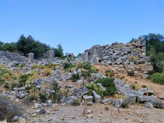 Pinara ruins of an ancient city near Fethiye, Mugla, Türkiye. Lycian tombs, ancient Roman amphitheater and mountains.