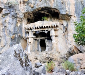Pinara ruins of an ancient city near Fethiye, Mugla, Türkiye. Lycian tombs, ancient Roman amphitheater and mountains.