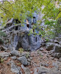 Pinara ruins of an ancient city near Fethiye, Mugla, Türkiye. Lycian tombs, ancient Roman amphitheater and mountains.