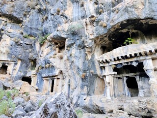 Pinara ruins of an ancient city near Fethiye, Mugla, Türkiye. Lycian tombs, ancient Roman amphitheater and mountains.