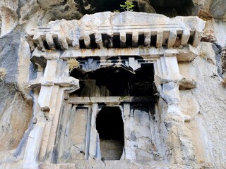 Pinara ruins of an ancient city near Fethiye, Mugla, Türkiye. Lycian tombs, ancient Roman amphitheater and mountains.