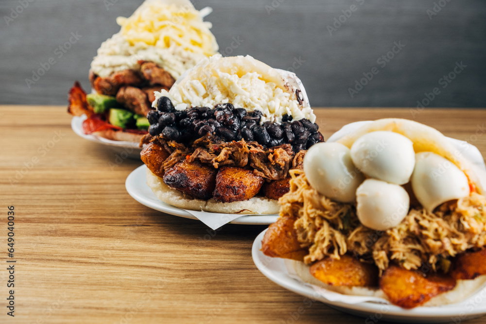 Wall mural group of delicious venezuelan arepas with different ingredients