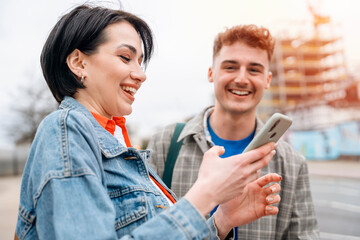 two friend, couple using phone, taking selfie , watching photos, having a fun in the city. Lifestyle concept