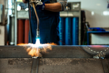 Heating up of metal construction with acetylene and oxygen burner in process of flame straightening...