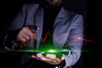 Man analyse stock market using mobile smart phone. Businessman holding smartphone and showing holographic graphs and stock market statistics lost profits. - obrazy, fototapety, plakaty