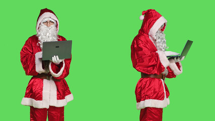 Saint nick using laptop on videocall, talking to people on online videoconference meeting and...