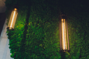 A classic Edison light bulb on black background with space for text.