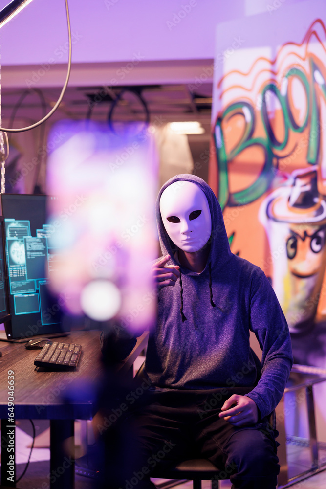 Poster anonymous hacker recording illegal activities on smartphone and pointing at camera. criminal broadca