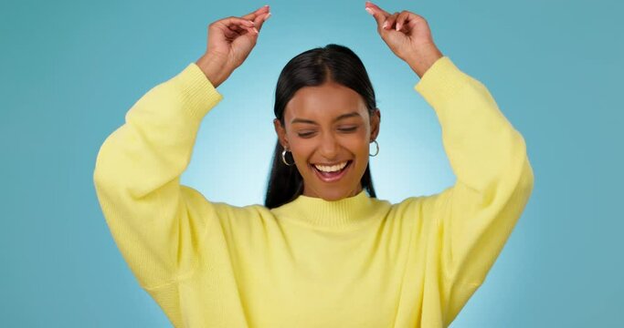 Excited, woman and dance for success in studio to celebrate party, promotion or winning lotto on blue background. Happy indian model, giveaway winner and energy for prize deal, disco music or freedom