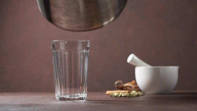 Masala tea is poured into a cut glass.Traditional Indian drink.