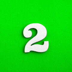 Number two - white number in wood on green background