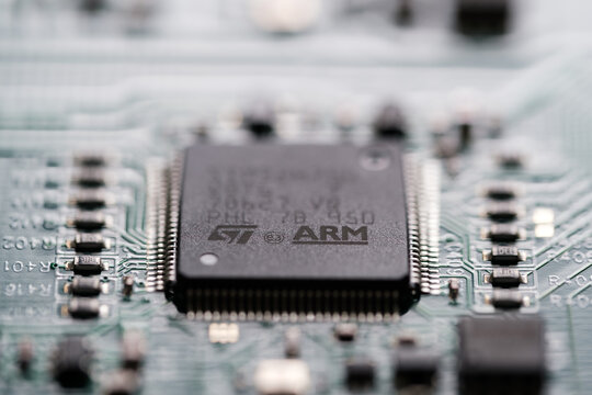 ARM company logo seen on microchip wich is soldered on a Printed Circuit Board (PCB).  Selective focus. London, United Kingdom, September 17, 2023