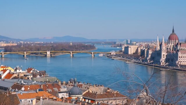 Budapest cityscape with secheni bridge. A view of chained Secheni bridge over Danube river against sunny Budapest buildings in the day light.