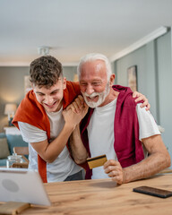 teenager and senior man grandfather use credit card shopping online