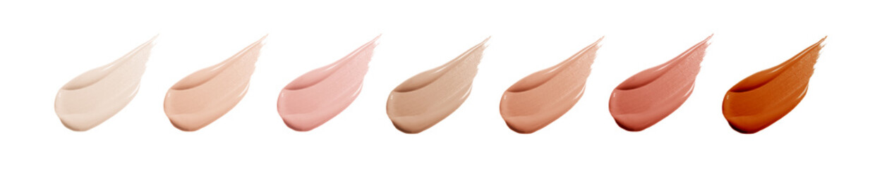 Different shades of liquid skin foundation on white background, top view. Set with samples of...