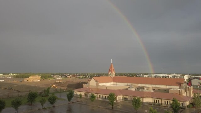 Rainbow after a storm over a church