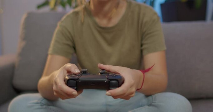 woman playing video games with controller in hand