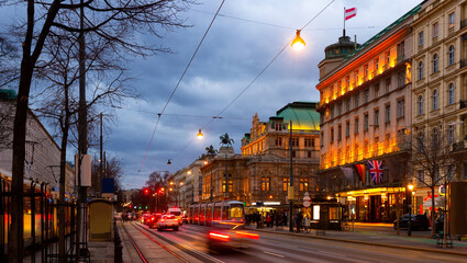 Wide shot of traffic passing the Opernring and Vienna State Opera in Vienna, Austria