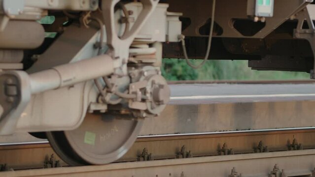 Video 4k. Train departure. Close-up view of wheels and rail. Train passes on rails. Bottom view.
