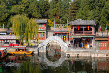 Beijing, China: Suzhou market street with a boat and bridge on the river