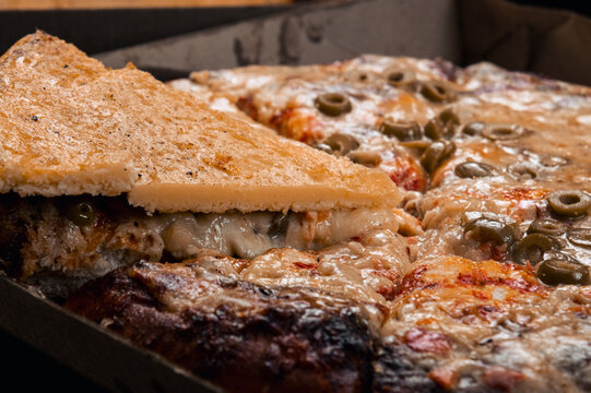 pizza is made of mozzarella and on top of it a portion of faina made of chickpeas