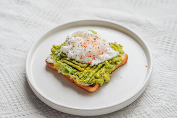 Breakfast: Toast with poached eggs and avocado.