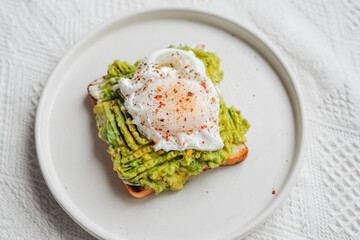 Breakfast: Toast with poached eggs and avocado.