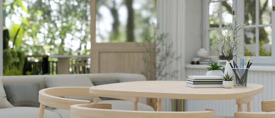 Close-up image of a copy space on a wooden table in a contemporary and comfortable living room.