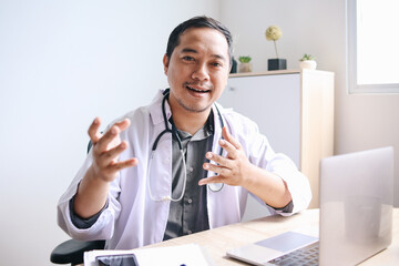 Asian Male doctor gesture explaining during tele medicine consultation 