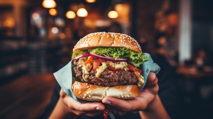 Female hand with delicious burger at burger shop - obrazy, fototapety, plakaty