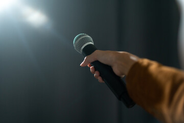 Close up woman hand holding High quality dynamic microphone and singing song or speaking talking...