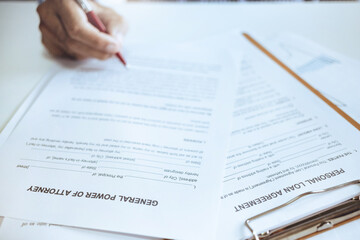 Human hands working with documents at desk reviewing business contract before signing in power of...
