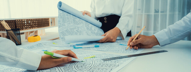 Worker, architect and engineer work on real estate construction project oratory planning with...