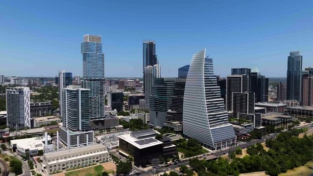 Aerial view approaching the skyline of downtown Austin, sunny day in Texas, USA