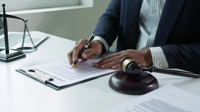 The lawyer or legal advisor reads and carefully checks the validity of documents and investment agreements for signing contracts managing justice concepts.