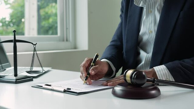 The lawyer or legal advisor reads and carefully checks the validity of documents and investment agreements for signing contracts managing justice concepts.