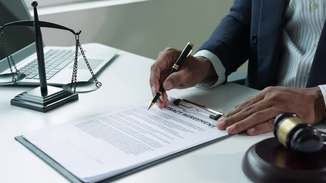 The lawyer or legal advisor reads and carefully checks the validity of documents and investment agreements for signing contracts managing justice concepts.