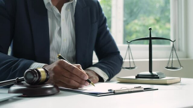 The lawyer or legal advisor reads and carefully checks the validity of documents and investment agreements for signing contracts managing justice concepts.