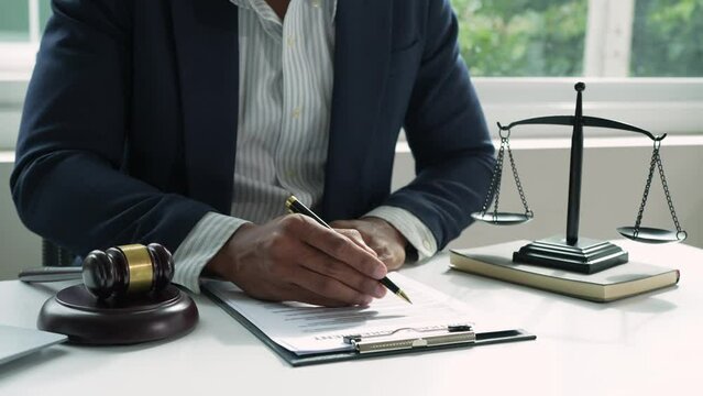 The lawyer or legal advisor reads and carefully checks the validity of documents and investment agreements for signing contracts managing justice concepts.