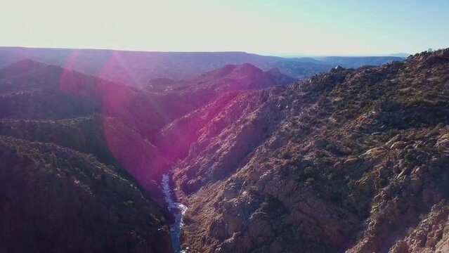 Desert Canyon with frozen stream & Purple lens flare, USA Southwest, Dixon New Mexico, 4K Drone Aerial