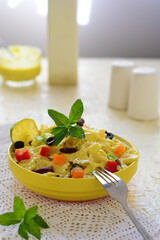 pasta salad with sauce , And fresh vegetables .