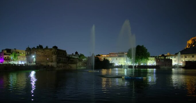 Night Jodhpur: view of lake with fountain and Mehrangarh Fort. Rajasthan, India. Horizontal camera panning