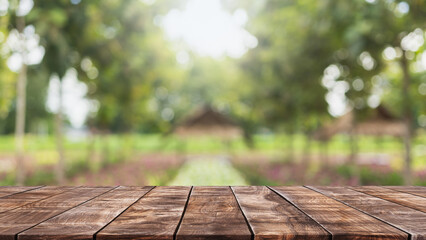 Empty wood table top and blurred green tree and fruit vegetable in agricultural farms background - can used for display or montage your products.