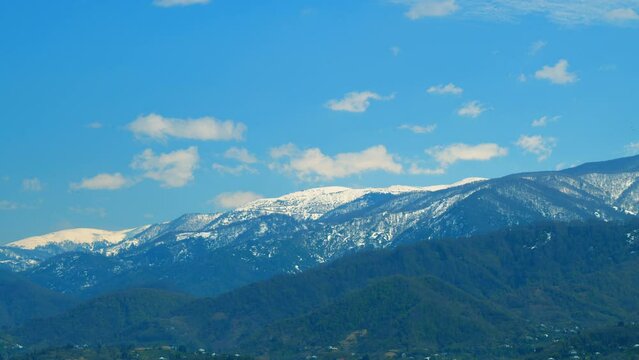 Beautiful View Of The Snow-Covered Spruce And Mountains. Blue Clear Sky. Real time.