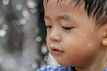 A carefree child reveling in the simple pleasures of summer, as they dance amidst the playful spray...