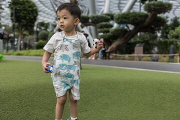 A happy kid embraces the magic of play amidst the enchanting mist at Foggy Bowl, Jewel Changi Airport.