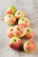Ripe juicy apples on a white wooden background. Healthy eating, fruits.